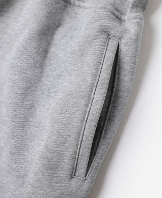 Gray terry sweatpants close-up of stitched seam and side pocket opening