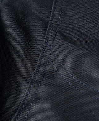 Navy canvas seam close-up showing reinforced stitching lines