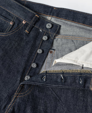 Indigo denim waistband close-up with button fly and multiple button closure