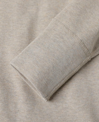 Light heather beige sleeve cuff with ribbed hem and stitched edge