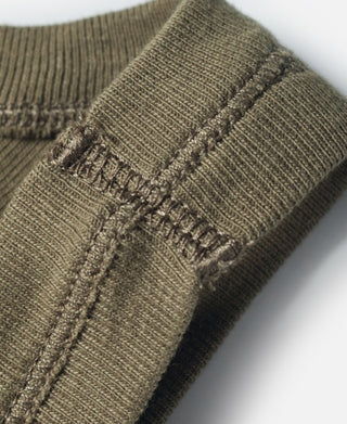 Olive tank top fabric seam with stitched detail at shoulder area