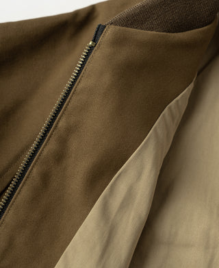 Brown bomber jacket with front zipper and ribbed knit collar close-up