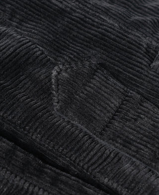 Black corduroy work pants fabric detail with raised wales texture