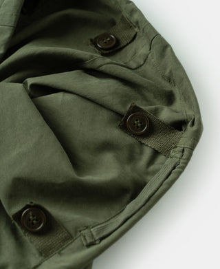 Olive arctic shell trousers with snap and button closure at inner waistband