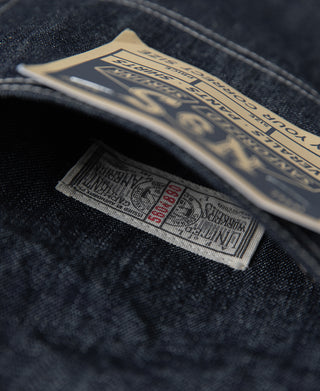 Indigo denim jacket interior care label with printed size and button details