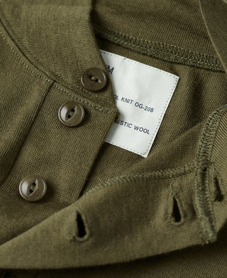 Olive wool henley label at button placket with metal button detail