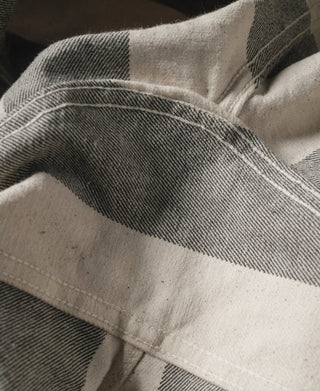 Wide striped prisoner pants with white and dark gray stripes, close-up of waistband stitching