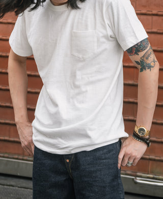 White pocket T-shirt worn by model with short sleeves
