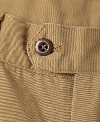 Tan chino trouser waistband with dark button closure at the fly