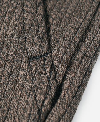 Brown salt-and-pepper striped pants close-up of side seam stitching