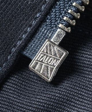 Navy deck jacket zipper pull with metal stencil badge detail