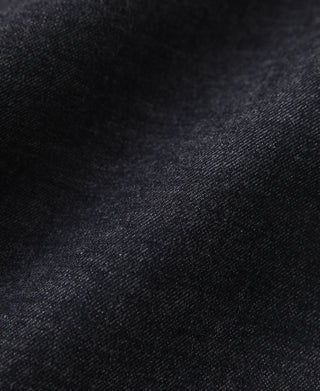 Indigo selvedge denim fabric close-up showing textured weave and color depth