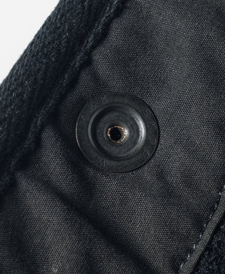 Dark salt-and-pepper wool vest button with round front closure