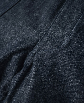 Close-up of dark navy denim panel with subtle fading and textured weave