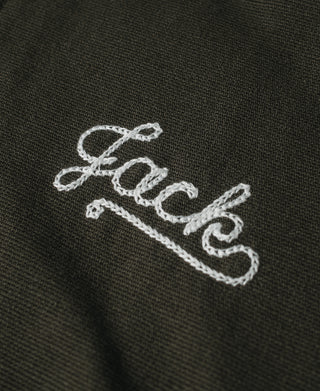 Olive jacket close-up of “Jack” script embroidery in white thread