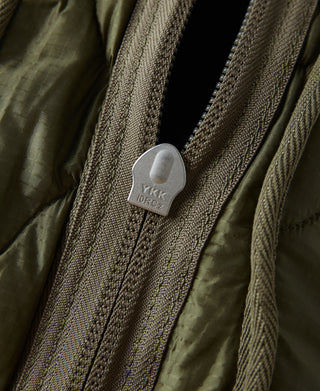 Olive waist bag zipper with metal pull tab and logo patch detail