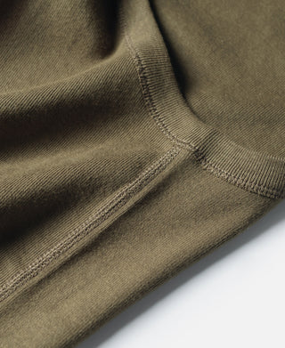 Olive cotton tank top hem and side seam with stitched edging detail