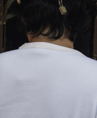 Back view of white waffle-knit cotton underwear top with textured fabric