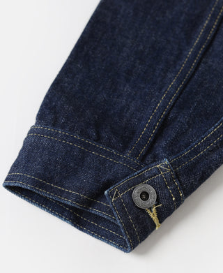 Indigo denim jacket cuff with metal snap and yellow topstitching