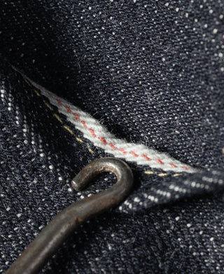 Indigo selvedge denim jeans with metal eyelet and contrast stitched seam detail