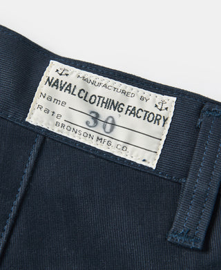 Navy deck pants care label at waistband with printed size 30 details.