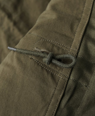 Olive field jacket cuff with drawstring tie and stitched tab