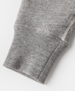 Gray raglan-sleeve sweater cuff and ribbed hem, knit texture close-up