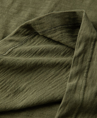 Green cotton T-shirt shoulder seam with tubular gusset detail