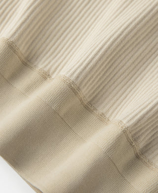Apricot ribbed henley long-sleeve shirt, cuff and button placket close-up