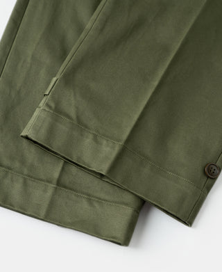 Olive trouser leg with stitched cuff hem and side fold detail.