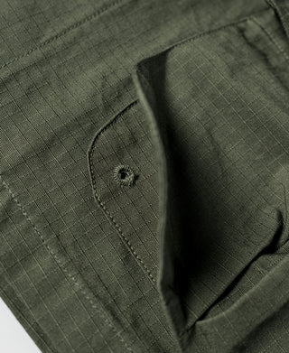 Olive jacket inner pocket with stitched tab and small buttoned emblem