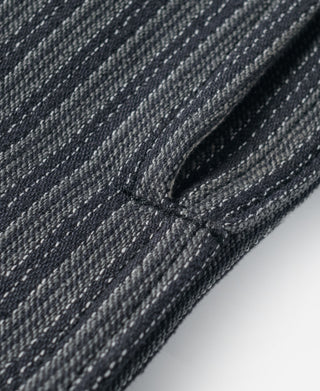Detail of black and gray striped fabric on the pants leg