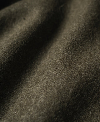Khaki olive tanker jacket fabric close-up with textured weave