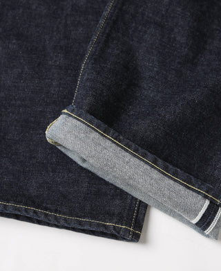Indigo selvedge denim jeans cuff with light inner hem and yellow edge stitching