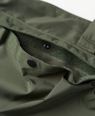 Olive nylon bag front panel with snap buttons and reinforced opening