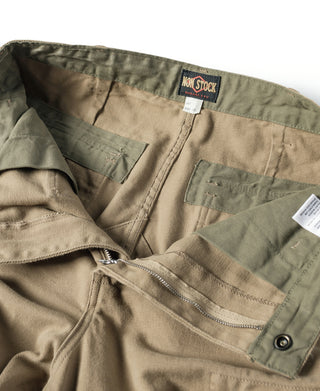 Khaki field pants with drawstring-style waistband, zip fly, and multi-pocket design