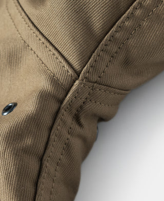 Khaki deck jacket sleeve cuff close-up with sewn seam and snap