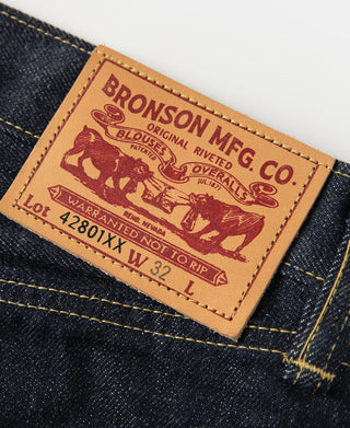 Indigo selvedge denim jeans tag close-up with Bronson Mfg. Co. logo