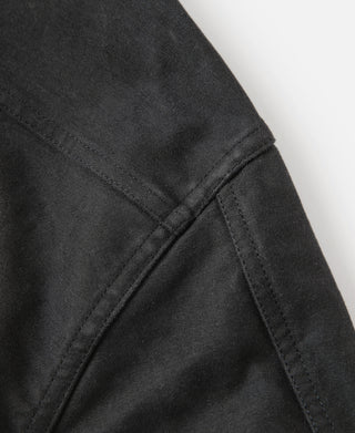 Black moleskin cossack jacket, close-up of diagonal seam and contrast stitching