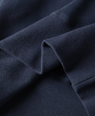 Navy raglan sweatshirt sleeve fabric with ribbed knit folds