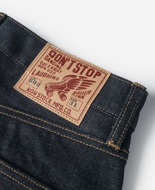 Indigo selvedge denim jeans with leather-look back patch on waistband