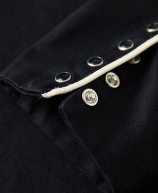 Black western shirt cuff with contrast white trim and silver snap buttons