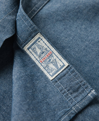 Blue chambray work shirt interior label at cuff seam
