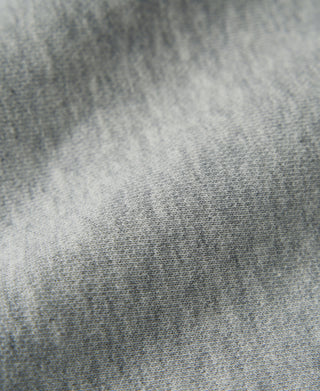 Gray terry cloth sweatpants fabric texture close-up, fine looped knit.