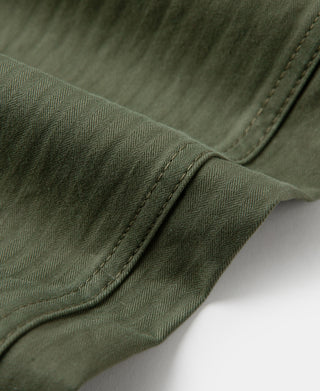 Olive fatigue trousers, knee seam with curved pocket stitching