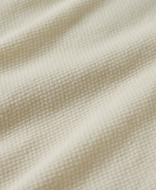 Cream waffle knit fabric texture close-up