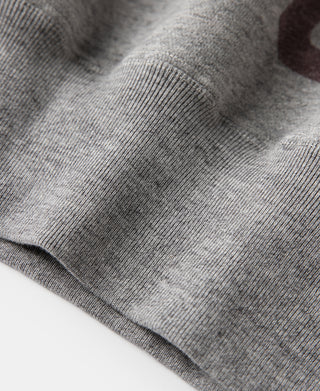 Gray knit fabric texture on sweater sleeve and shoulder seam