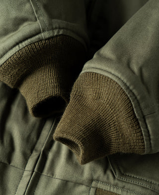 Olive flight jacket knit cuff and elastic sleeve hem with stitched seam