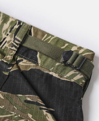 Tiger stripe camo fatigue pants waistband with elastic and adjustable strap detail.