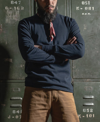 Navy long-sleeve henley shirt worn by a man with button front.